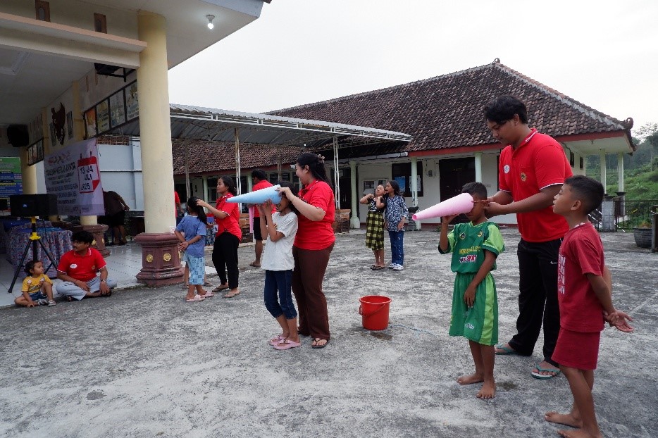 Lomba memindahkan air kedalam botol dengan di tutup kertas karton. (doc. pribadi)