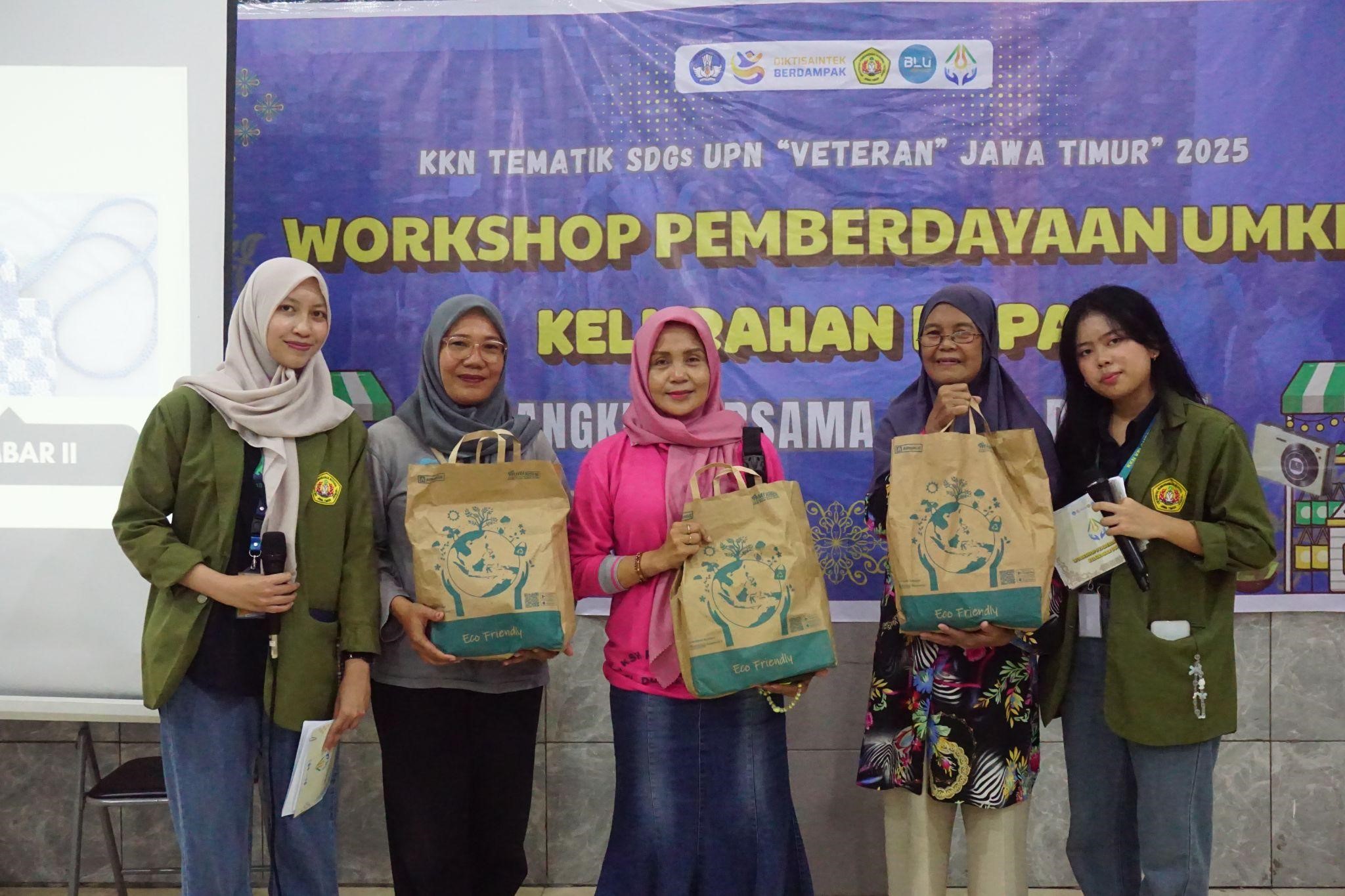Pemberian souvenir untuk peserta yang terpilih saat workshop Strategi Posting Media Sosial dan Pembuatan Caption. (doc. KKN SDGs 10 UPN “Veteran” Jawa Timur)