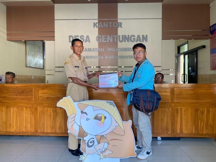 Mahasiswa KKN UNS Kelompok 66 melakukan penyerahan Maskot Desa Gentungan kepada Bapak Suwito selaku Kepala Desa Gentungan sebagai upaya memperkuat branding desa melalui simbol identitas lokal. (doc. KKN 66 UNS)
