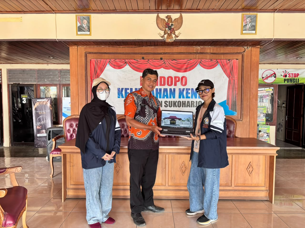 Penyerahan website Kelurahan Kenep yang telah dikembangkan oleh mahasiswa KKN-T IDBU 64 kepada Lurah Kelurahan Kenep. (Doc. Pribadi)